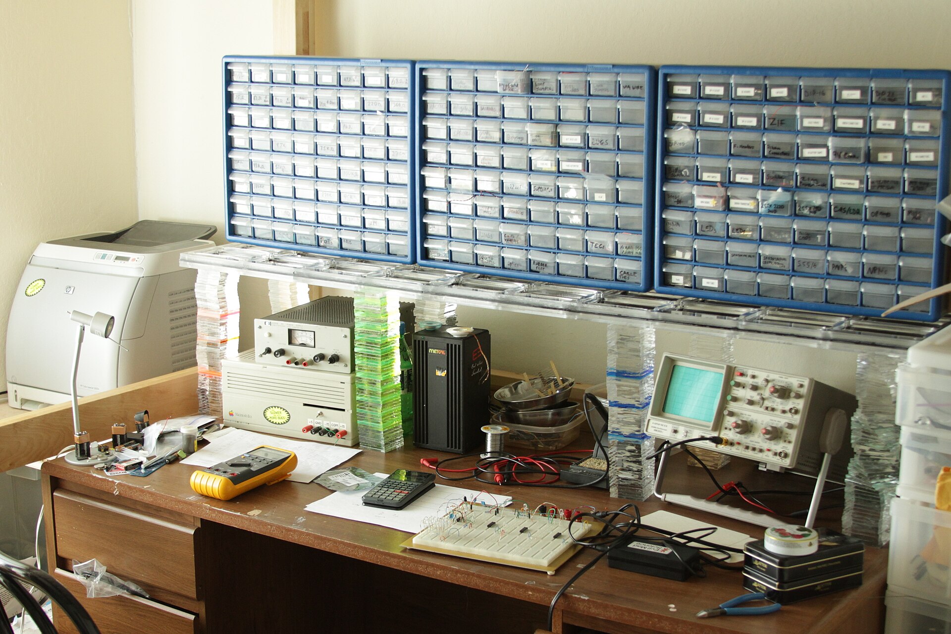 A working electronics bench covered in tools, wire and parts